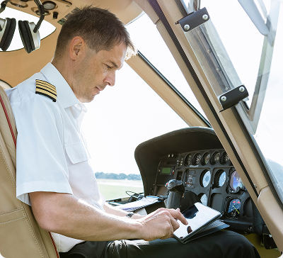 Pilot completing the technical log in the cockpit